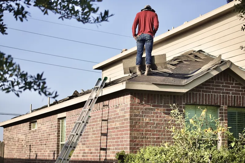 Professional roofer working on a residential roof in Leeland